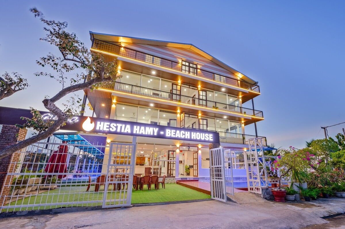 The lit façade of Hestia HaMy Beach House in the evening