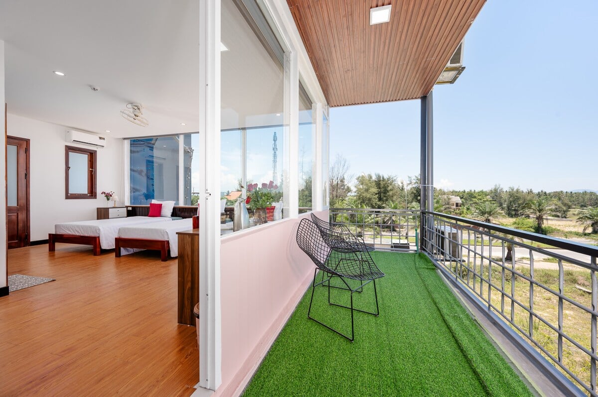 The room seen from the balcony through the open glass door