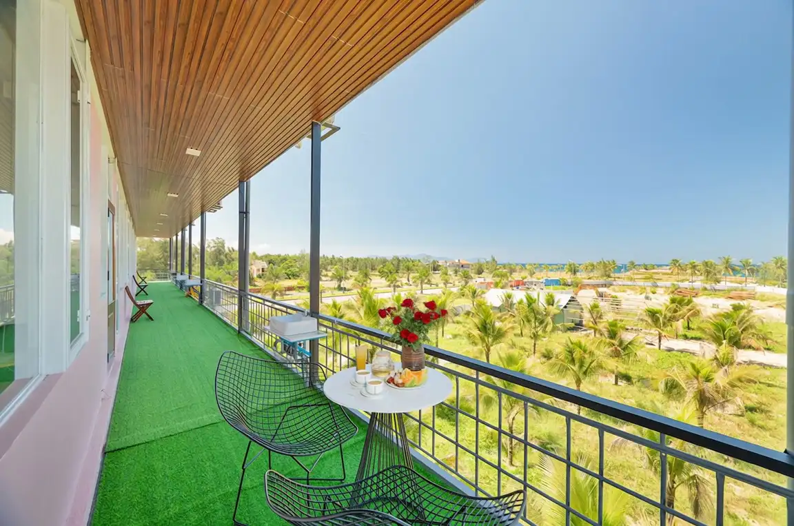 The balcony walkway above the palms